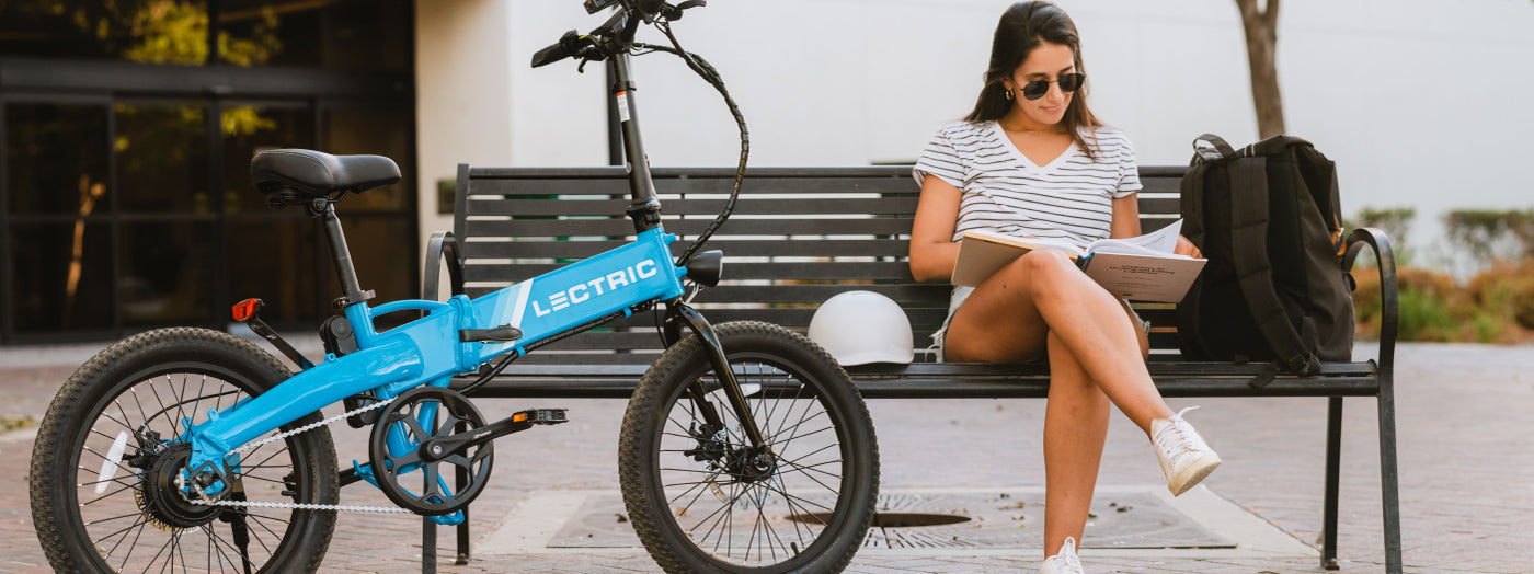 College Student Reading a Text book featuring commute with Lectric eBikes XP Lite