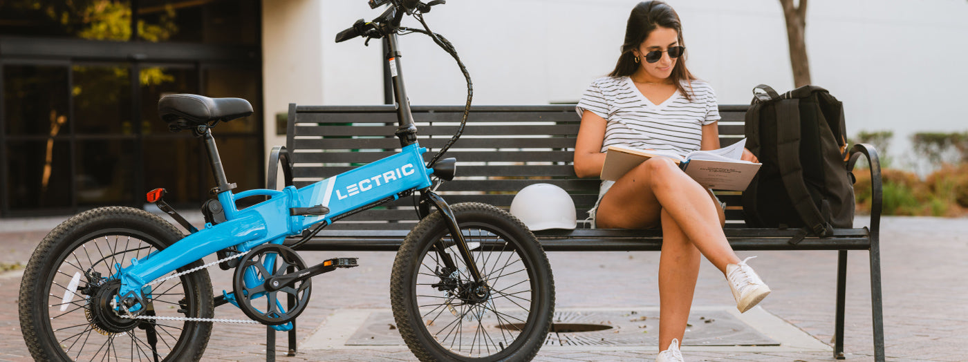 College Student Reading a Text book featuring commute with Lectric eBikes XP Lite 