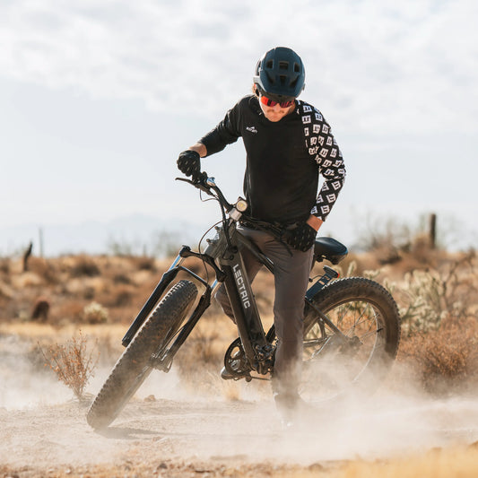 guy riding XPeak through dirt in desert