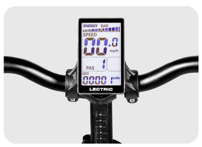 A close-up view of an XP 3.0 Long-Range eBike's digital display mounted on the handlebars. The display shows various metrics including speed (0.0 mph), pedal assist level (PAS 1), odometer reading (0.0 miles), and battery energy levels in a bar format, perfect for longer adventures to explore further.