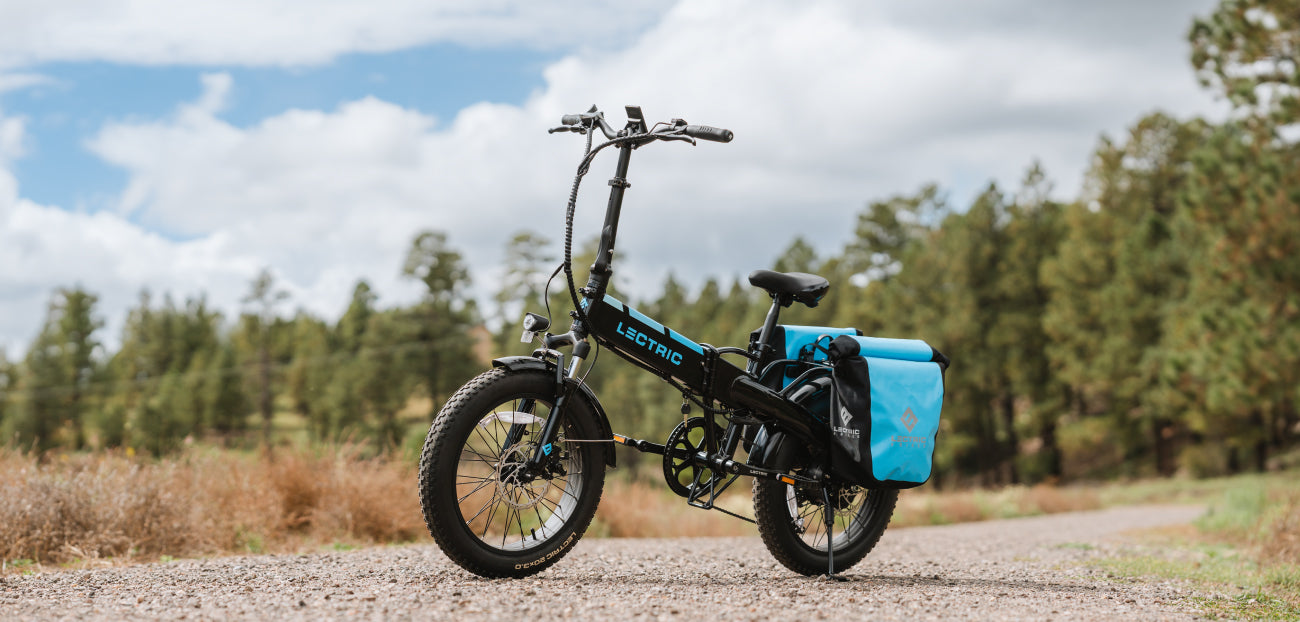Lextric XP 3.0 Black XP ebike with waterproof pannier bags on trail in forrest