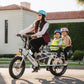 Mom driving two children around on Lectric XPedition cargo eBike with orbitor, seats, and running boards attached
