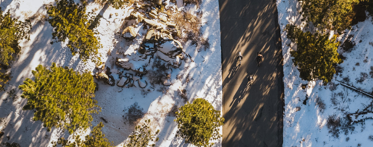 overhead photo of a road with snow around it and riding Lectric ebikes