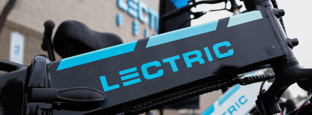 Close up photo of a Lectric XP top tube with Lectric Showroom in the background