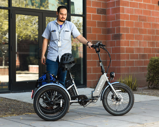 maintenance worker using XP Trike to get around college campus with tools