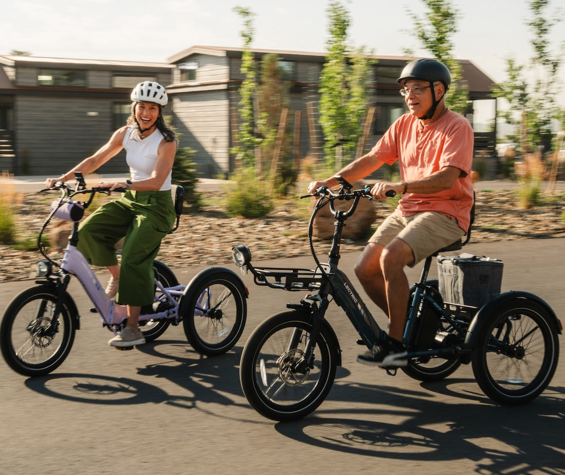 Man and woman riding Lectric XP Trikes eBikes at camping location
