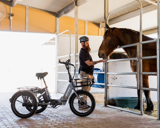 man using XP Trike to deliver carrots to a horse at Phoenix Zoo