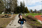 kid with a bike helmet on a scooter