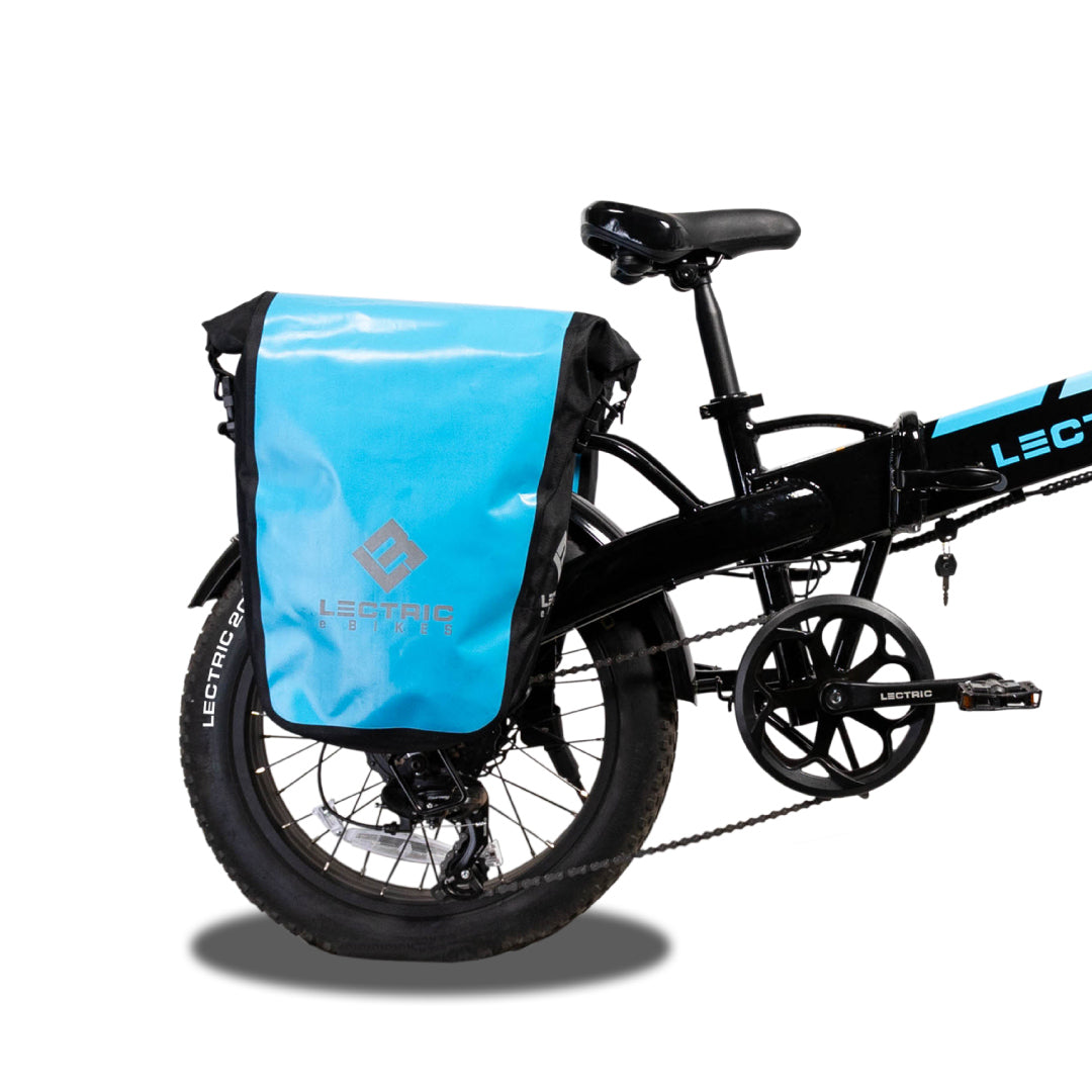 Blue Waterproof pannier bag installed on a rear rack of an ebike on a white background