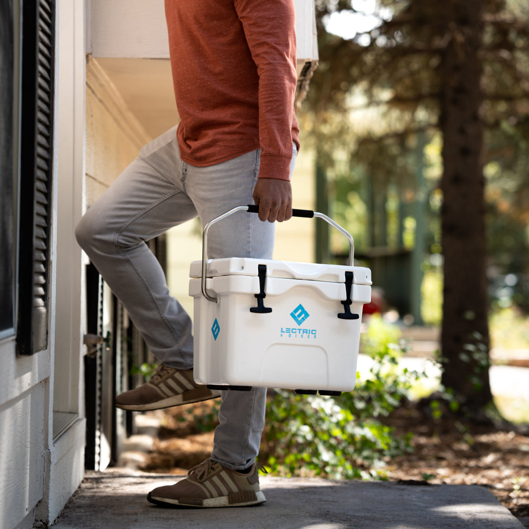 Man holding Lectric Hard Cooler by handle cushion and taking it to his home