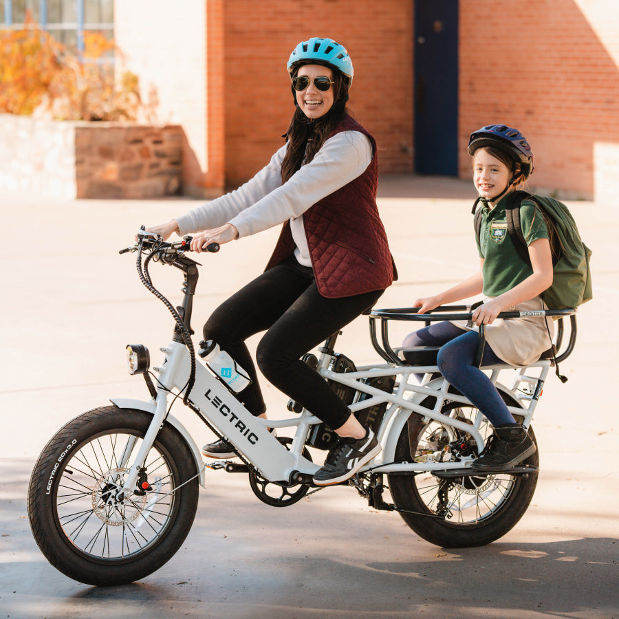 mom riding lectric xpedition cargo ebike with orbitor and child