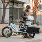Man loading cases of water into orbitor and groceries in XL Cargo panniers on Lectric XPedition