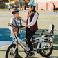 woman dropping off son at basketball practice with xpedition ebike